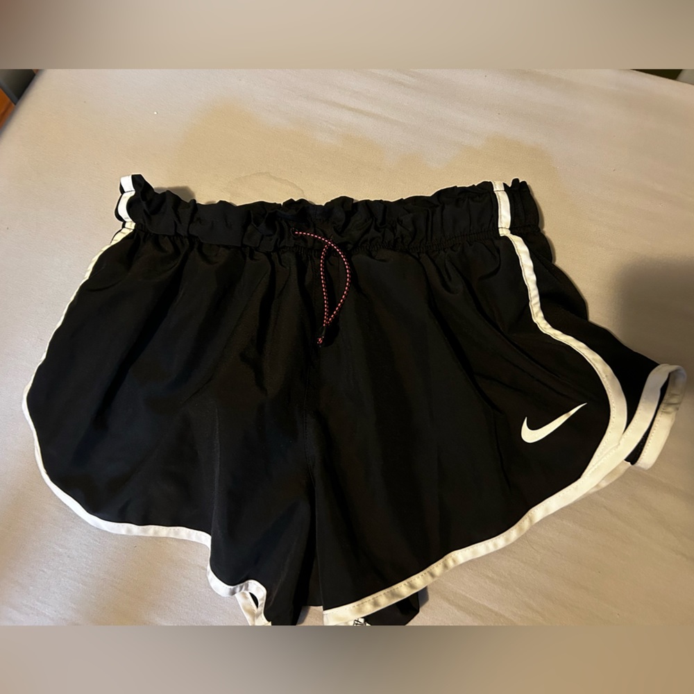 Nike dry fit shorts. Black with white stripe. Cinched around the waist.